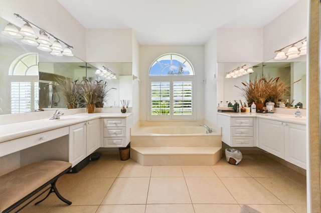 bathroom featuring plus walk in shower, vanity, and tile patterned flooring