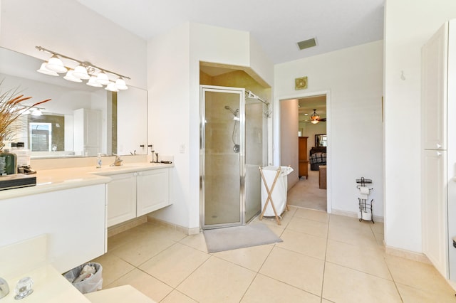 bathroom featuring walk in shower, vanity, tile patterned floors, and ceiling fan