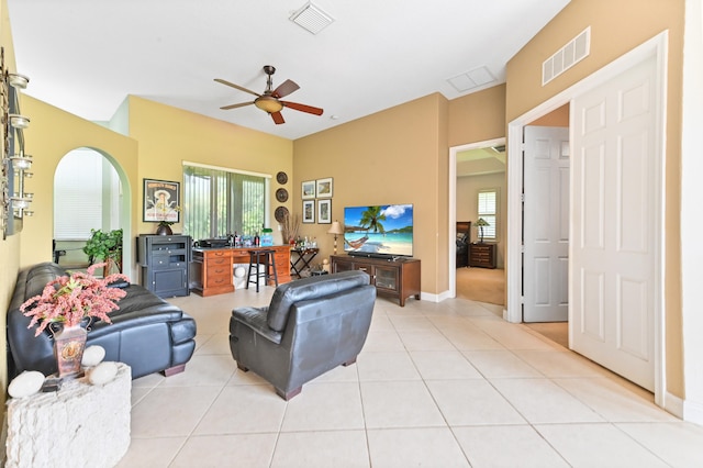 living room featuring light tile patterned floors and ceiling fan