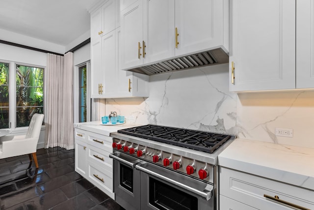 kitchen featuring backsplash, light stone counters, white cabinets, and double oven range