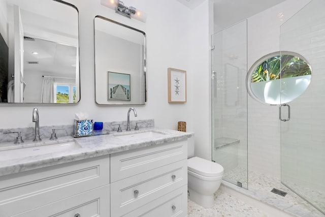 bathroom with vanity, toilet, and an enclosed shower