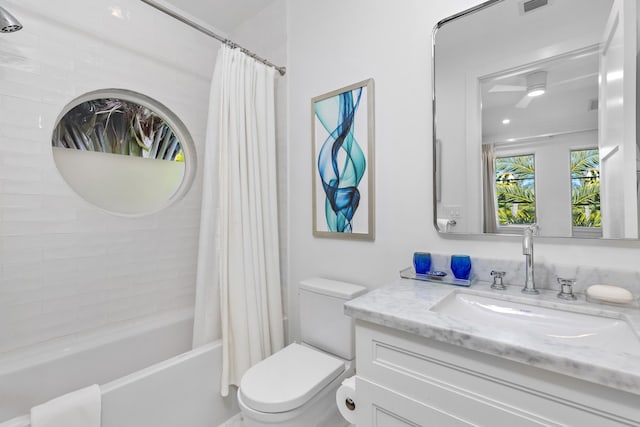 full bathroom featuring vanity, shower / bath combination with curtain, and toilet