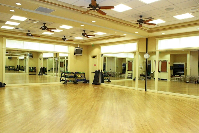 workout area with hardwood / wood-style floors, a paneled ceiling, basketball court, and a raised ceiling