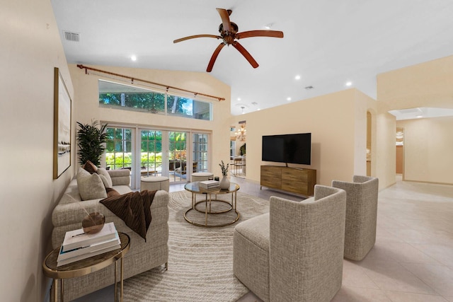 living room with ceiling fan, french doors, light tile patterned flooring, and vaulted ceiling