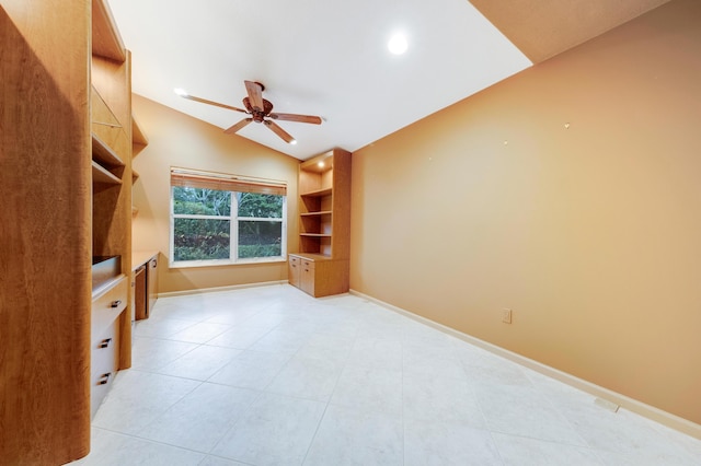 interior space featuring ceiling fan, light tile patterned floors, and vaulted ceiling