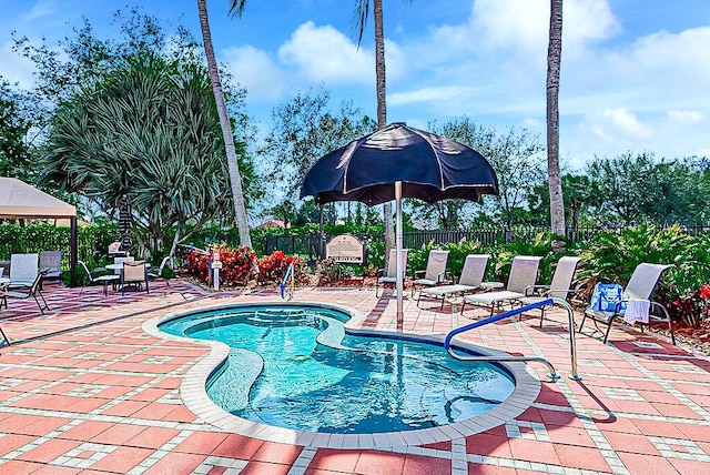 view of swimming pool featuring a gazebo and a patio area