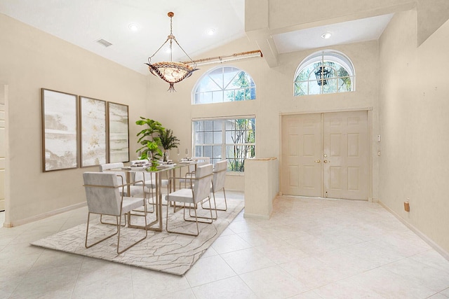 entrance foyer with light tile patterned floors and a high ceiling