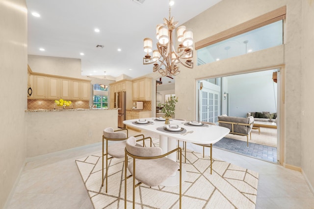 tiled dining space with a notable chandelier