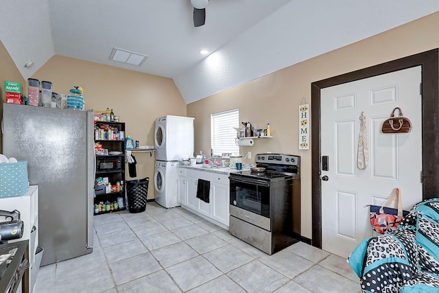 kitchen with stacked washer and dryer, vaulted ceiling, ceiling fan, white cabinetry, and stainless steel appliances