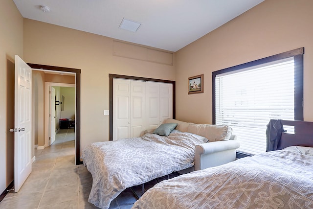 tiled bedroom featuring a closet