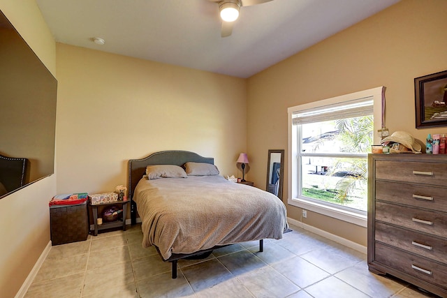 tiled bedroom featuring ceiling fan