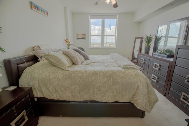 carpeted bedroom with multiple windows and ceiling fan