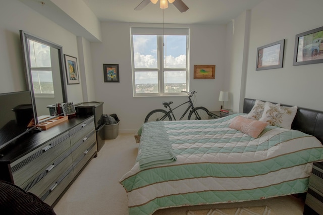 bedroom featuring light carpet and ceiling fan