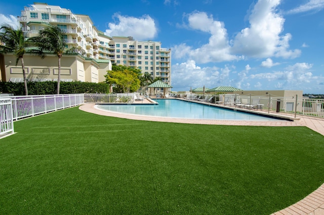 view of swimming pool with a lawn