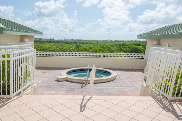 view of patio with an in ground hot tub