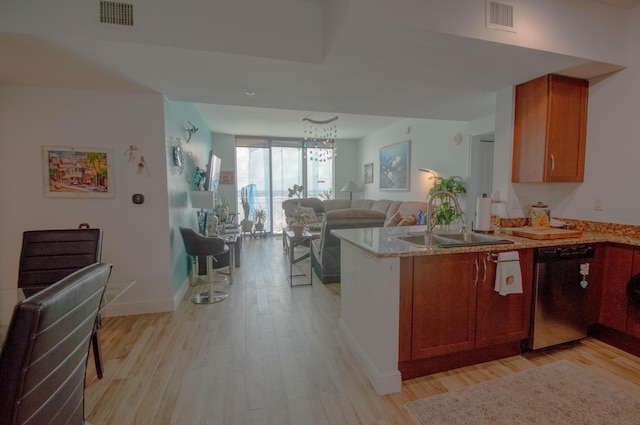 kitchen featuring kitchen peninsula, sink, stainless steel dishwasher, and light wood-type flooring