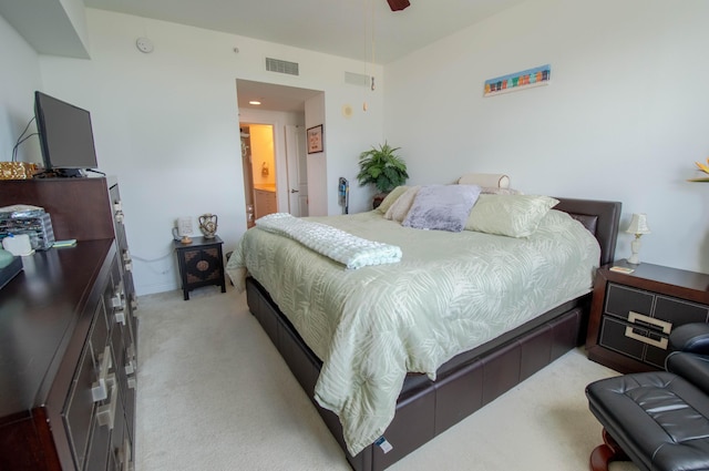 carpeted bedroom featuring ensuite bathroom and ceiling fan