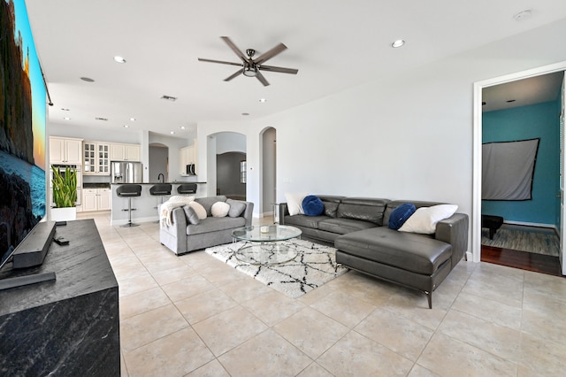 tiled living room featuring ceiling fan