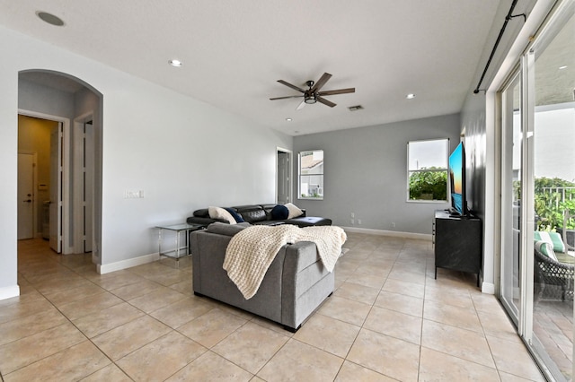 tiled living room with ceiling fan