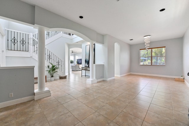 unfurnished room with a chandelier, light tile patterned floors, and plenty of natural light