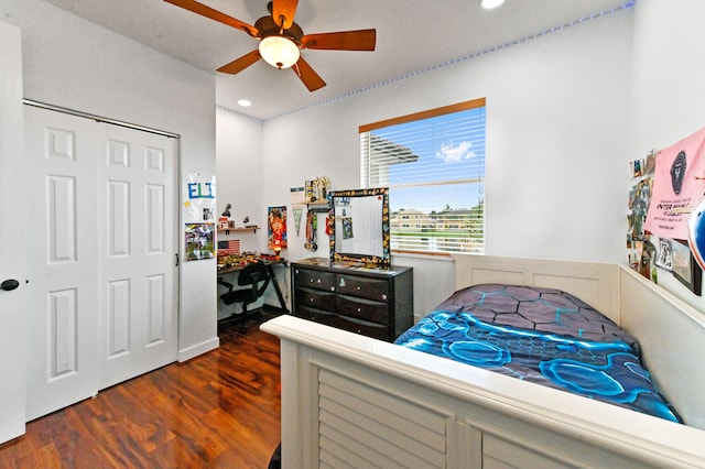 bedroom featuring ceiling fan, a closet, and dark hardwood / wood-style flooring