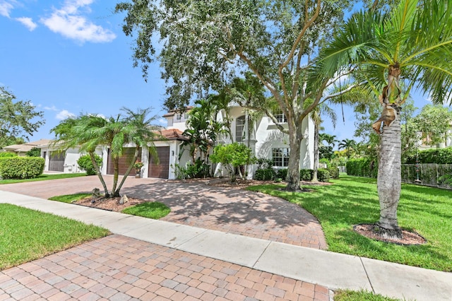 mediterranean / spanish home with a garage and a front yard