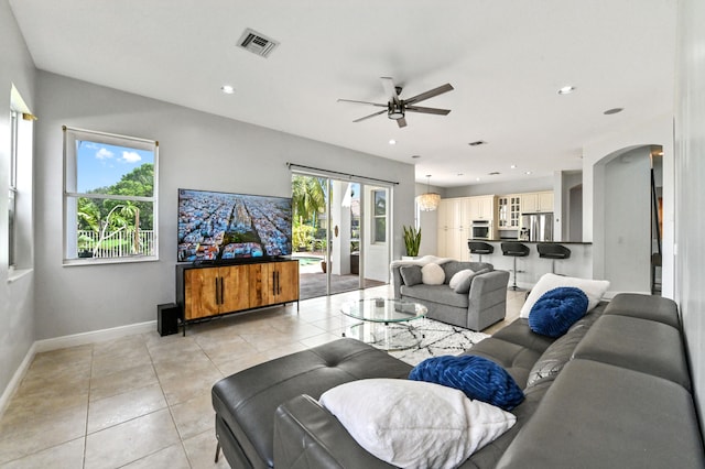 tiled living room featuring ceiling fan