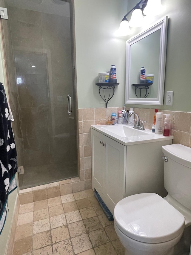 bathroom with tile walls, toilet, decorative backsplash, and walk in shower