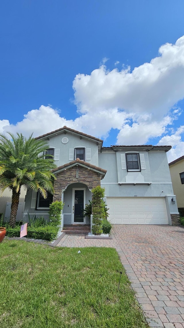 view of front of home with a garage and a front lawn