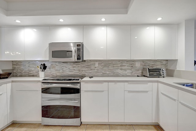 141 SW 96th Ter Unit 302, Plantation, FL 33324 - kitchen with appliances with stainless steel finishes, light tile patterned floors, and white cabinetry