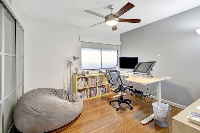 office space with hardwood / wood-style floors, a textured ceiling, and ceiling fan