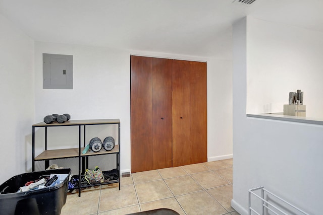 interior space with electric panel and light tile patterned floors