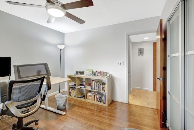 office space with hardwood / wood-style flooring and ceiling fan