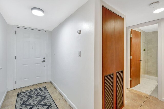 doorway to outside with light tile patterned floors