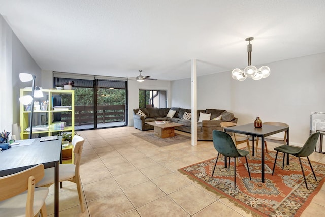 dining room featuring ceiling fan with notable chandelier and light tile patterned floors