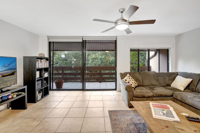 living room with ceiling fan and light tile patterned floors