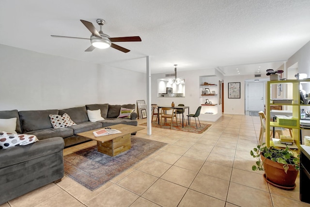 tiled living room featuring ceiling fan and a textured ceiling