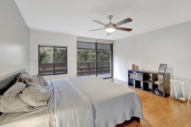 bedroom featuring ceiling fan, access to outside, and wood-type flooring