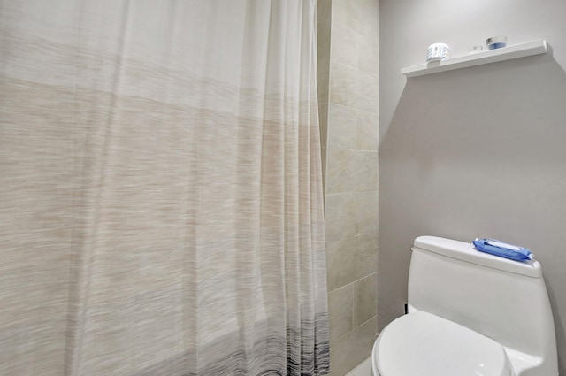 bathroom with a shower with shower curtain and toilet