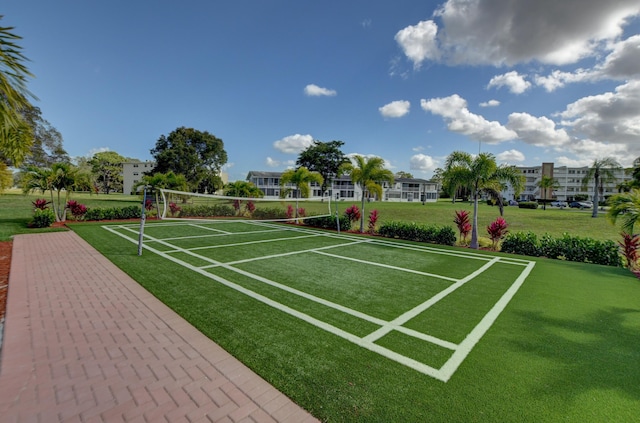 view of community featuring volleyball court and a yard