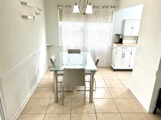 interior space featuring light tile patterned flooring and a chandelier