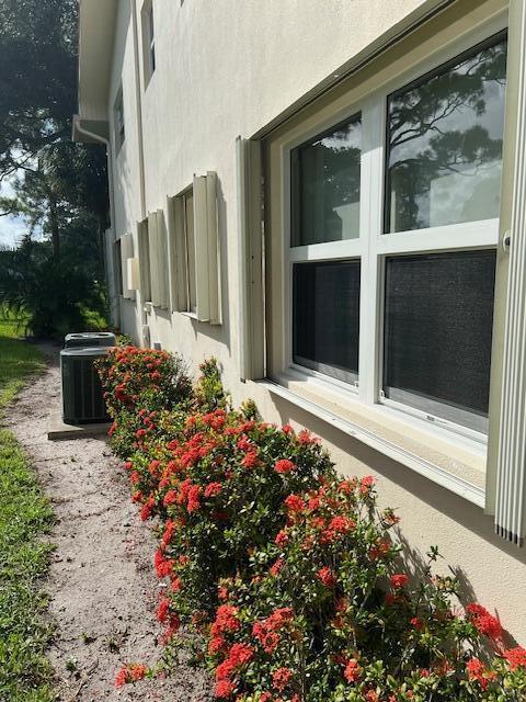 view of side of home with central air condition unit