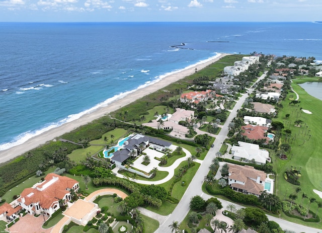 drone / aerial view featuring a beach view and a water view