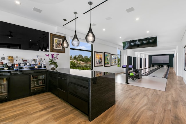 kitchen with pendant lighting, light hardwood / wood-style floors, and wine cooler