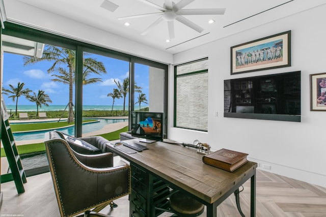 office area with ceiling fan and light parquet floors