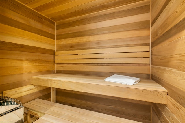 view of sauna with wooden walls