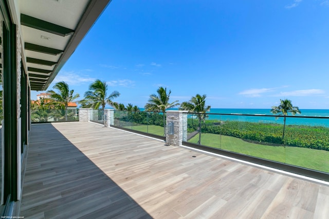 wooden terrace featuring a water view