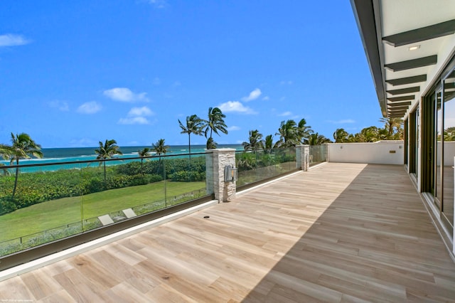 wooden deck featuring a water view and a yard