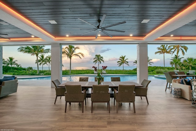 interior space featuring a water view and ceiling fan