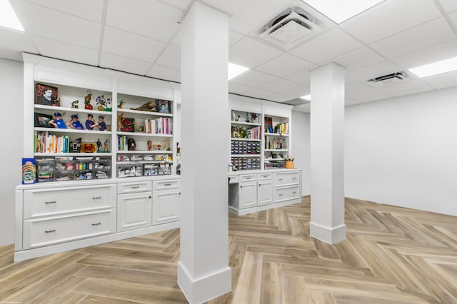 interior space featuring light parquet floors and a drop ceiling